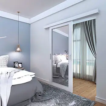 Residential interior contemporary white painted mirrored wood surface mounted sliding door